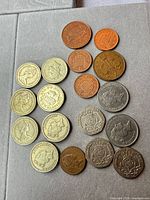 Entire grouping of 18 U.K. coins laid out: left column £1, centre 1p/2p, right 20p