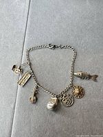 Full view of bracelet showing chain, clasp and all seven charms