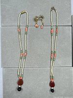 Full view of necklace laid out and screw-back earrings