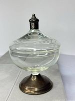 Full view of glass compote with lid and weighted base attached