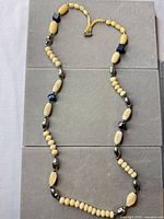 Full view of necklace showing bead sequence and clasp