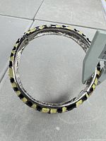 Interior view of hinged bangle showing silver-tone finish and wear
