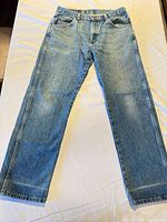Full view of front of jeans laid flat