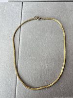 Full view of the 18 inch yellow gold tone box chain necklace laid flat