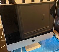 Front view of Apple 27-inch iMac showing screen and aluminum chin with logo