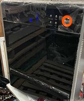 Front view showing control panel and black glossy surface