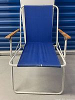 Front view of blue folding lawn chair showing seat, back and frame