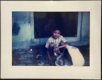 Front view of framed color photograph showing young boy subject, mat and frame visible