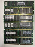 All eight DIMM modules stacked to show overall lot contents and comparative sizes