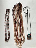Three necklaces displayed flat