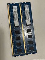 Front view of both Nanya DDR3 modules showing gold contacts and black memory chips