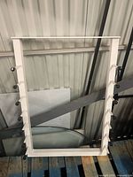 Full view of white metal rack showing 14 pegs and overall design