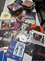 Wide shot of table with stacks of 45s showing various picture sleeves