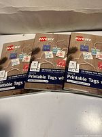 Three sealed boxes of Avery white printable tags with strings