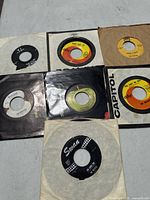Overview of seven Beatles 45 rpm records in sleeves
