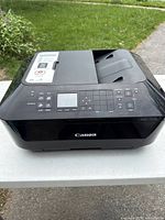 Front angled view of Canon PIXMA MX722 printer showing control panel and Canon logo