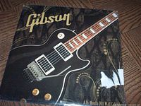 Front cover showing Gibson logo, guitar image, shrink wrap