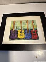Overall view of framed guitar print showing colors, mat, and frame