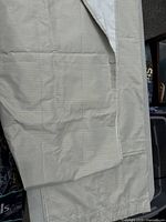 Full view of one off-white silver-striped curtain panel showing size and lining