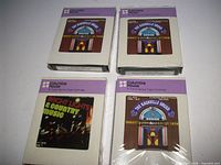 Front view of four Columbia House 8-track tapes in sleeves