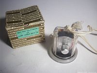 Overall view of meter in housing beside original box