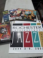 Group shot showing Jazz Festival sign, Kiss cereal box, and four magazines