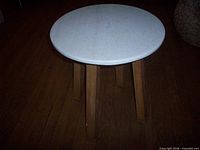 Full view of table showing round marble top and legs
