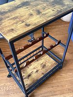 Three-quarter view of entire cart showing top, bottle racks, bottom shelf and casters