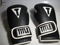 top view showing black leather fists with T logos