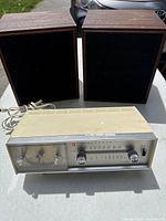 Panasonic clock radio front with pair of RCA speakers behind