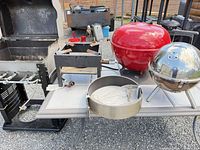 Overview of multiple grills, propane stove, burner parts