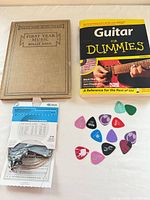 Lot overview showing two books, string pack, assorted picks