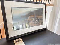 Framed print on table showing overall frame and mat