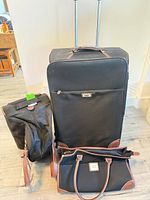 Front view of suitcase, duffel and tote together