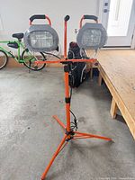 Full view of HDX dual-head halogen work light on orange tripod