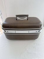 Front view of brown Jetliner hardshell train case showing overall design and size
