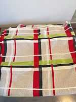Folded plaid bedspread showing pattern and texture