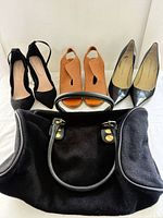 Group shot of handbag and three shoe pairs