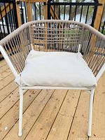 Front view of woven rope lounge chair showing cushion and frame