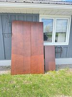 Front view of two large panels and one smaller leaning against wall