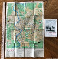 Full view of folded-out Rome city map with booklet for scale