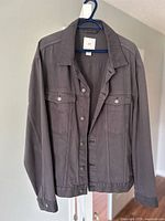 Front view hanging; shows color, button front, chest pockets, collar