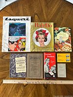 Group shot of all eight paper items with ruler for scale