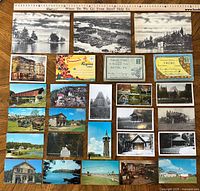Full layout of collection showing jumbo cards, souvenir folders and standard postcards with ruler for scale