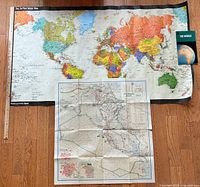 Group shot of three maps with yardstick for scale