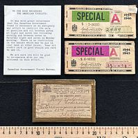 Group shot of all four pieces: registration card, two ration books, travel bureau notice