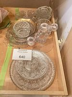 All items grouped in drawer showing platters, small bowls and candle holder