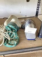 Bissell corded handheld vacuum alongside Shark cordless handheld vacuum, cords visible