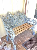 Front view of ornate cast iron and wood bench