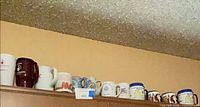 Full lineup of mugs on cabinet top